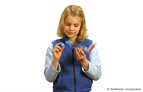 A child removing the cap from the spacer