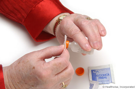 Wiping the rubber lid with alcohol