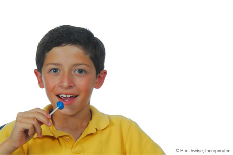 Person getting quick sugar from a lollipop